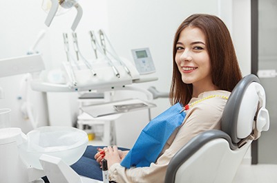 smiling woman sitting in a dentist’s chair