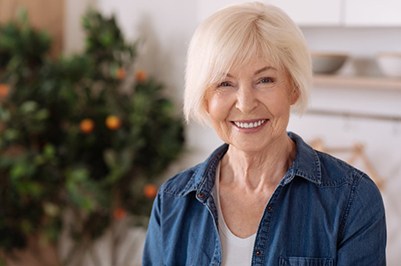 an older woman smiling while at home