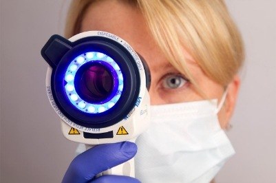 Dentist performing oral cancer screening