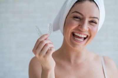 Woman holding a nightguard for bruxism