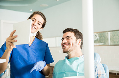 Woman sharing smile and enjoying the benefits of dental crowns