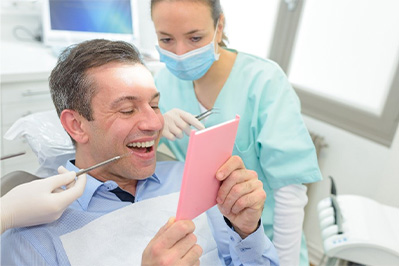 Woman sharing smile and enjoying the benefits of dental crowns