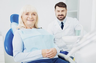 Woman smiling with dentures in Putnam