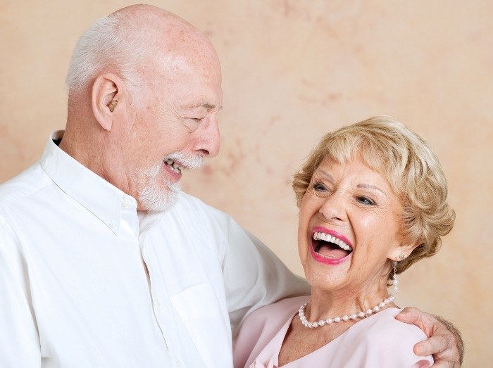 Smiling man and woman with dentures