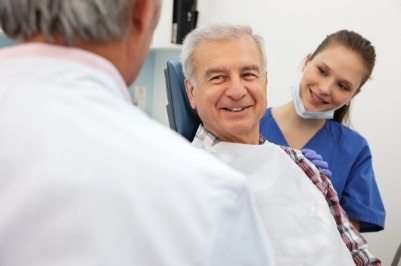 Man smiling at dentist during emergency dentistry visit