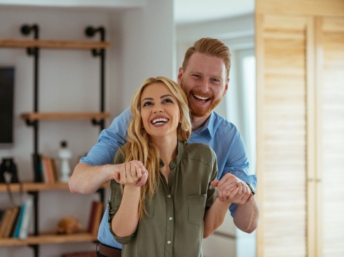 Man and woman sharing healthy smiles after gum disease treatment