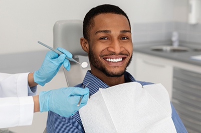 Patient smiling in dentist's treatment room