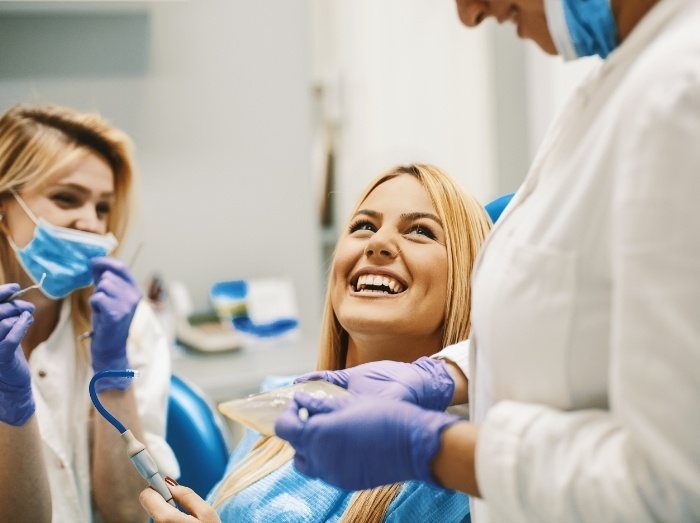 Woman smiling while receiving dental services in Putnam Connecticut