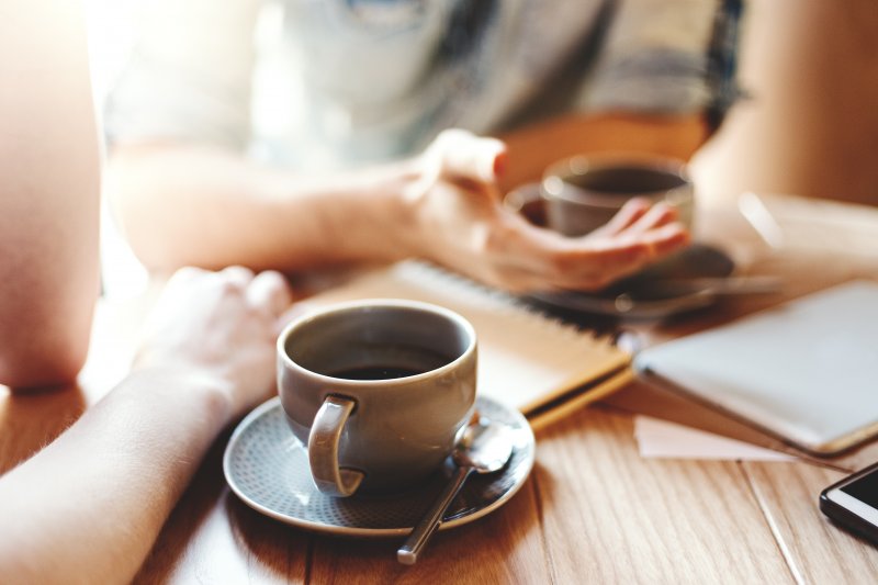 friends talking while drinking coffee