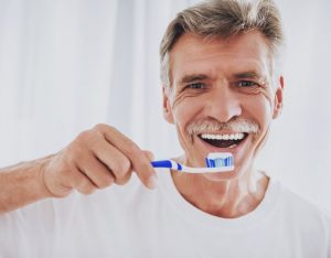 older man about to brush teeth