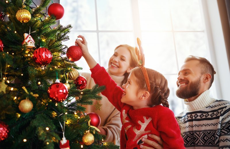 family decorating Christmas tree