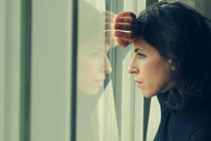 A woman looking out her window.