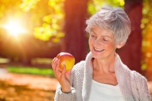 woman smiling at apple