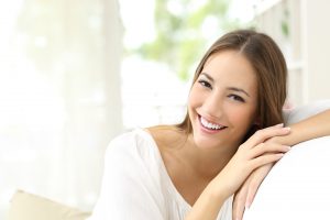 Smiling woman with improved teeth from her Putnam cosmetic dentist