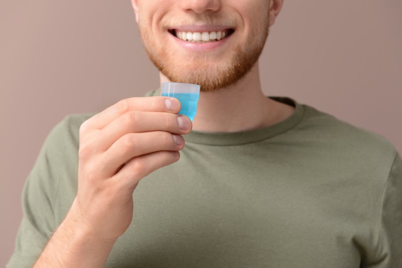 Man holding mouthwash