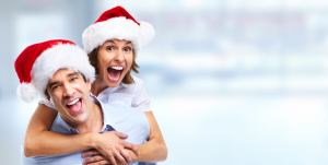 Couple in Santa hats smiling