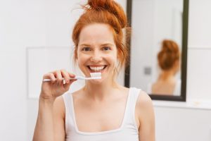 Woman smiling and getting ready to brush teeth