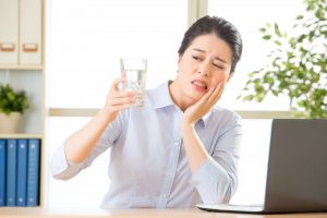 woman frowning from tooth sensitivity